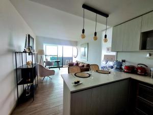 a kitchen and living room with a table and a couch at Antofagasta Mistico-SOLO ADULTOS in Antofagasta