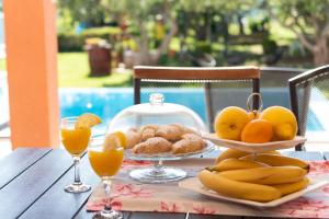 Apartman Rita with pool في قشتيلا: طاولة مع صحن من الفواكه وعصير البرتقال