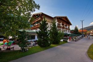 a large building with trees in front of it at Landhotel Denggerhof in Mayrhofen