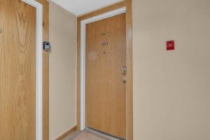 an empty hallway with a wooden door in a room at Charming Studio in the Heart of Park City in Park City