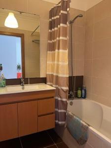 a bathroom with a sink and a tub and a shower at Santa luzia Tavira 5min walk to Praia do Barril in Tavira +4 photos
