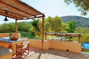 a patio with a table and chairs and a view at Elounda Collection Villa in Vrouchas