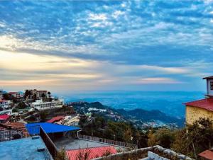 a view of a city from the top of a hill at The Boho Heritage near Mall Road in Mussoorie