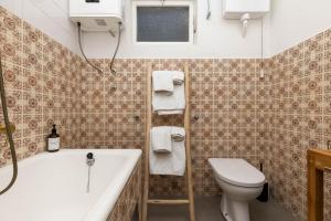 a bathroom with a tub and a toilet and a sink at Enolabee in Mali Lošinj +42 photos