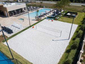 an overhead view of a pool with a volley ball court at Modern and Luxury 4 suites Villa near Disney 7521 in Orlando
