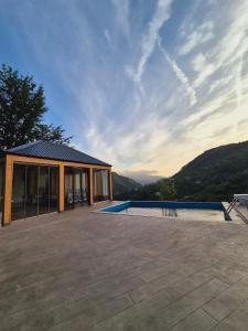 a house with a swimming pool next to a building at Hill sunny2024 in Zemo Jocho