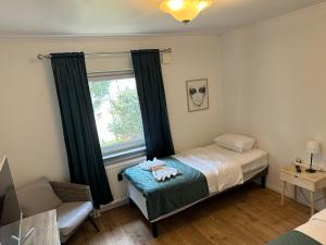 a bedroom with a bed and a window at Turtles Hotel in Ängelholm