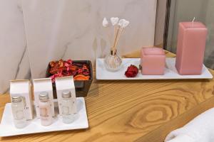 a table topped with two trays with candles and flowers at Sun Suite Luxury Pantheon in Rome