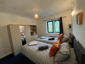 a bedroom with two beds and a window at Cosy 2-Bed Apartment in Manchester in Manchester