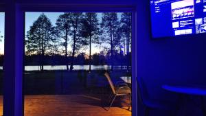 a room with a sliding glass door with a view of a lake at Auksi puhkemaja-2 in Auksi