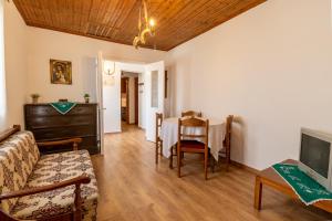 a living room with a couch and a table at Antonis Traditional House in Lixouri