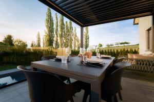 a dining room table and chairs on a patio at Ferienhaus mit Pool an der Südsteirischen Weinstraße in Berghausen