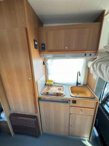 a small kitchen with a sink in an rv at Camping Van in Keflavík