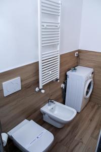 a bathroom with a toilet and a water heater at La Stella di Via Venezia in Marina di Carrara