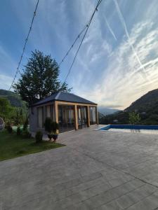 a house with a large patio and a pool at Hill sunny2024 in Zemo Jocho
