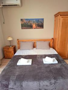 a bedroom with a bed with two towels on it at Garden of Eden - Studio in Sveti Vlas