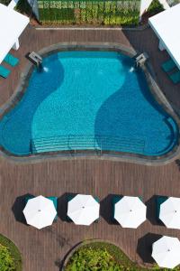 an overhead view of a swimming pool with umbrellas at Mandarin Oriental, Jakarta in Jakarta