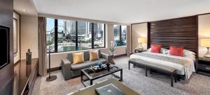 a hotel room with a bed and a large window at Mandarin Oriental, Jakarta in Jakarta