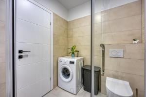 a bathroom with a washing machine and a toilet at Apartment Luana with private pool in Poreč +5 photos