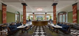 a restaurant with tables and chairs and a bar at Mandarin Oriental Palace, Luzern in Lucerne