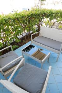 two chairs and a table and chairs on a patio at Settessenze Residence & Rooms in Agropoli