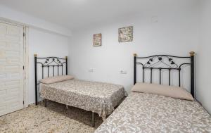 two beds sitting next to each other in a room at La Piriposa in Chilches +49 photos