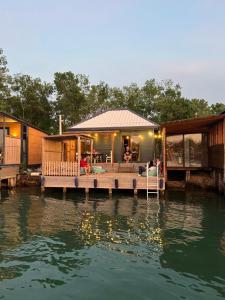 a house on a dock on a body of water at Barbana Cottage , Ada Bojana in Ulcinj