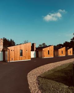 a row of wooden buildings on a road at River Bann Retreat in Portglenone