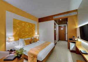 a hotel room with a bed and a television at Hotel Ocean Inn Near Delhi Airport in New Delhi