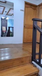 a room with a wooden staircase and a door at Yellow House in Manizales