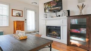 a living room with a fireplace and a wooden table at Splash Haven in Ottawa