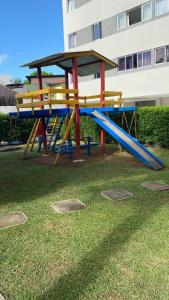 a playground with a slide in the grass at Morada dos Colibris in Natal +18 photos