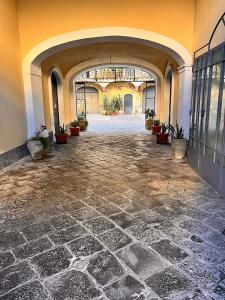 an empty hallway with a stone floor in a building at B&B Kike in Catania