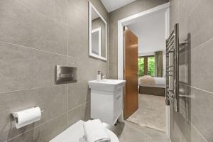 a bathroom with a toilet and a sink and a mirror at Springfield Fourteen in Harrogate +33 photos