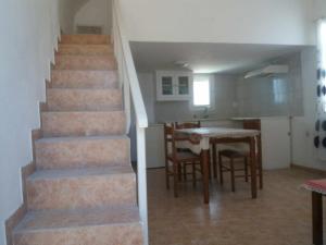 a staircase in a house with a kitchen and a table at Paradise Serenity in Thólos +7 photos