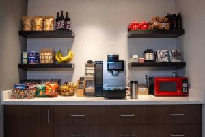 a kitchen with a counter with a coffee maker and food at Hotel 43 Boise in Boise +43 photos