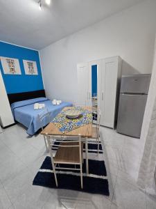 a room with a dining table and a bed at Destinazione Mare Naxos in Giardini Naxos