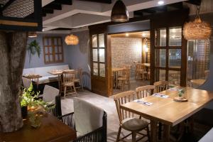 a restaurant with wooden tables and chairs and windows at Marbore hotel & Spa in Bogotá