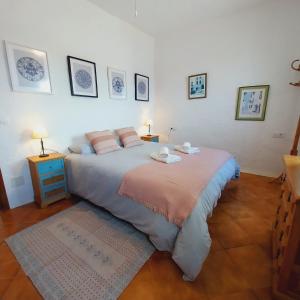 a bedroom with a large bed with two pillows at Apto POBLET by MENORCAHOST - Vistas únicas al mar en Playas de Fornells in Es Mercadal
