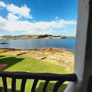 a view of the ocean from a window at Apto POBLET by MENORCAHOST - Vistas únicas al mar en Playas de Fornells in Es Mercadal +10 photos