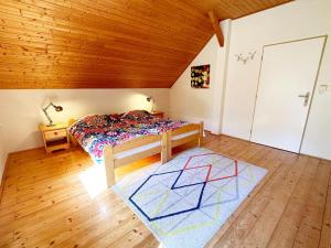 a bedroom with a bed and a wooden ceiling at Holiday Home in Rudn k with private garden in Rudník