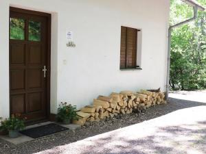 a pile of fire wood next to a door at Holiday Home in Rudn k with private garden in Rudník