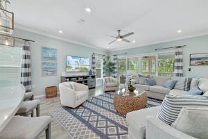 a living room with a couch and a tv at Carlinga Cottage at Lost Key Golf & Beach Club in Pensacola