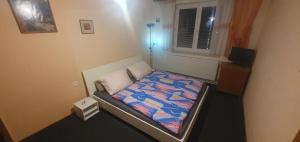 a small bedroom with a bed in a room at Lhotka Kopeček in Žďár nad Sázavou