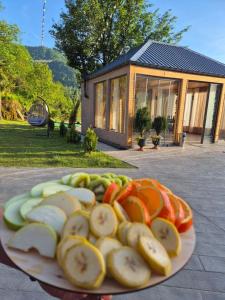 a plate of sliced vegetables on a table with a building at Hill sunny2024 in Zemo Jocho