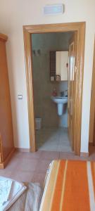 a bathroom with a toilet and a sink at Hostal San Julian in El Herrumblar