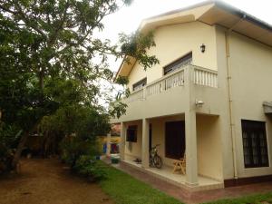 a house with a balcony on the side of it at Mallika Guest House in Hikkaduwa