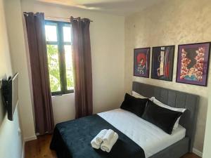 a bedroom with a bed with two towels on it at Diva Kapana 2BDR Apartment with parking in Plovdiv