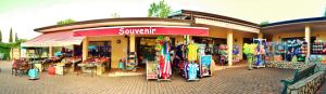 a store with a bunch of surfboards in front of it at Camping Bella Italia in Peschiera del Garda