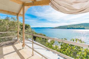 a view from the porch of a house overlooking the water at House Lady Anna in Pašman